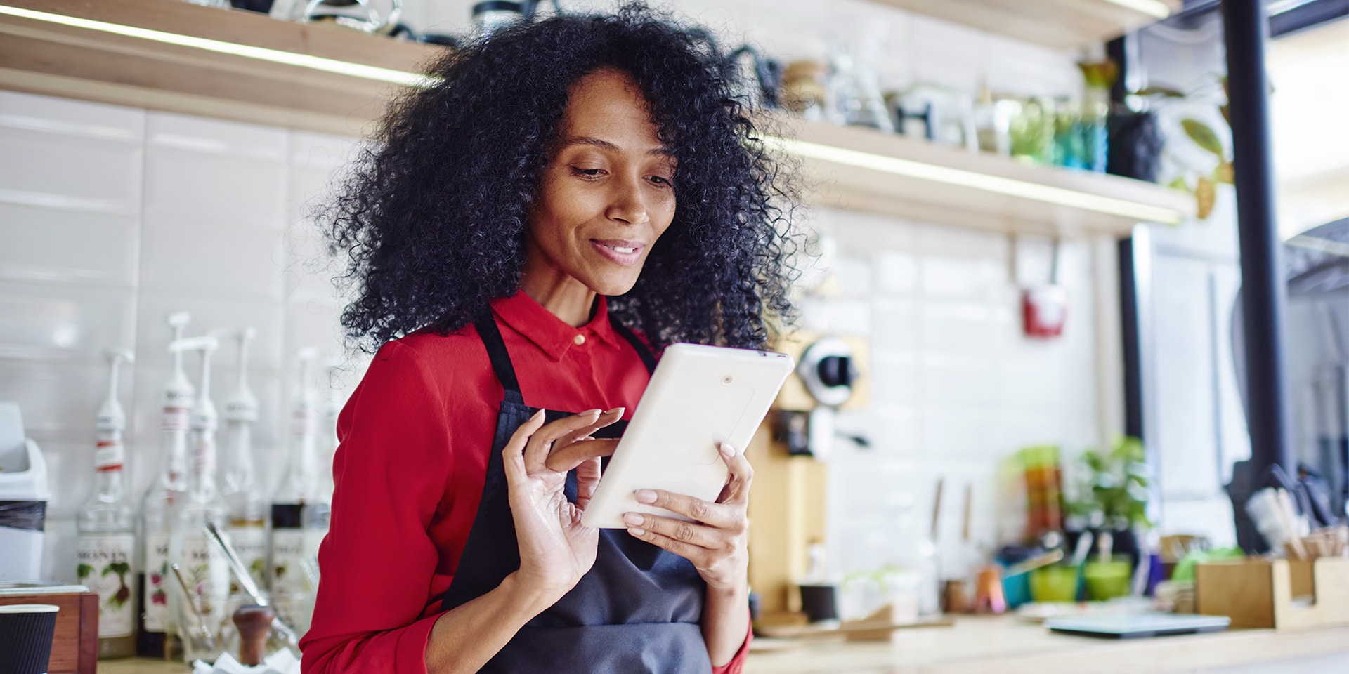 south african woman using tablet in cafe